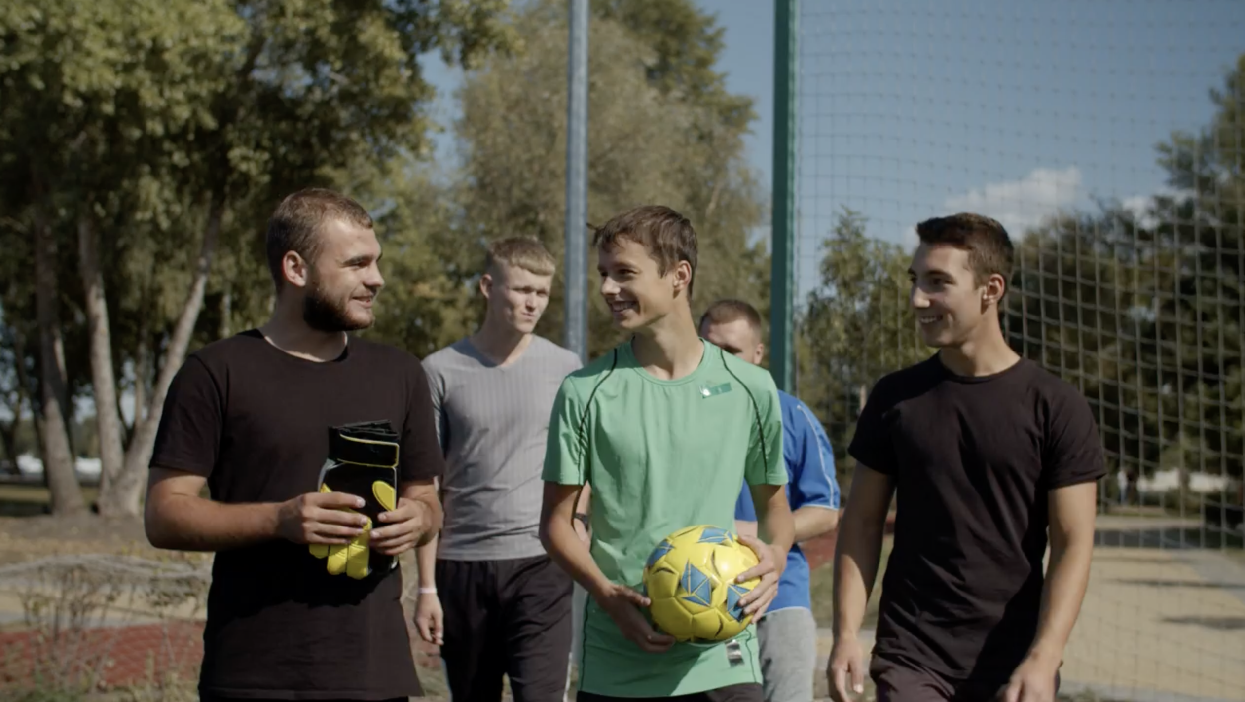 Friends celebrating a goal in an amateur football match